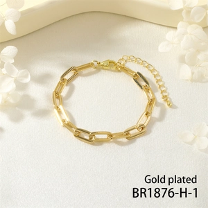 Detail of gold plated paperclip link bracelet with lobster clasp and extension chain
