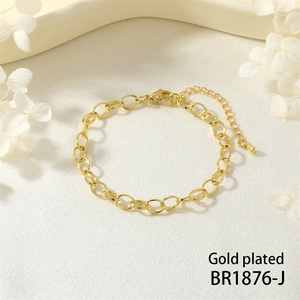 Detailed view of a gold-plated oval link bracelet with a lobster clasp and teardrop charm