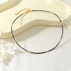 Delicate beaded clavicle chain with shimmering seed beads and gold metal details for daily wear.