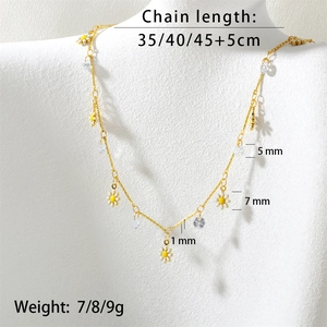Detail showing adjustable gold chain necklace lengths with daisy charms and clear zircons
