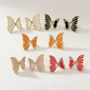 Detail of butterfly earrings set with gold plating, colorful enamel and micro crystals