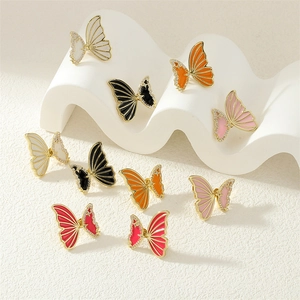 Macro detail of colorful butterfly earrings with gold plating and sparkling crystal accents