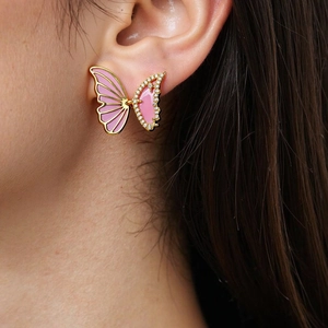 Detailed view of butterfly stud earrings with pink enamel and sparkling zircon stones