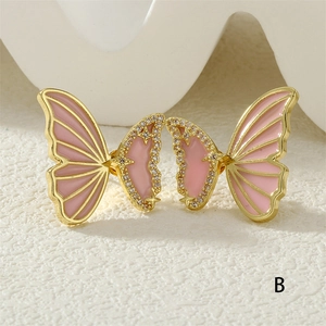 Detailed close-up of butterfly stud earrings with pink enamel and sparkling zircon pavé
