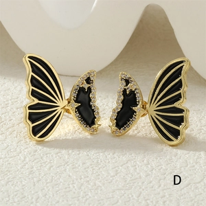 Detail of butterfly earring with gold plating, black enamel, and micro-set cubic zirconia