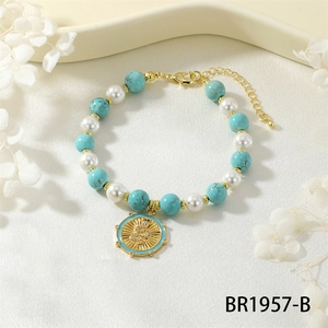 Detail of snake charm bracelet with turquoise beads, pearls and gold adjustable chain
