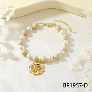 Detailed macro shot of an elastic pearl bracelet with snake charm and gold accents