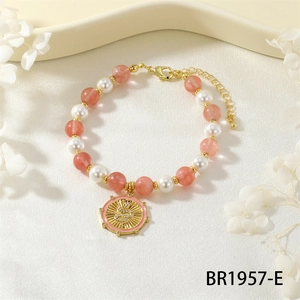 Close-up of strawberry crystal beads and pearl bracelet with golden snake charm