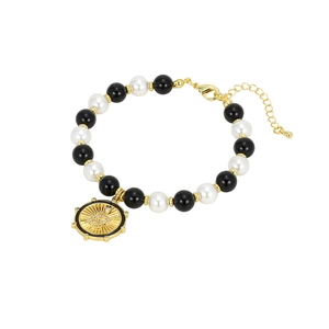 Bohemian beaded bracelet featuring black and white pearls with a golden snake coin pendant