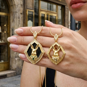 Detailed view of 18K gold plated rabbit zodiac pendants with zircons and snake chains