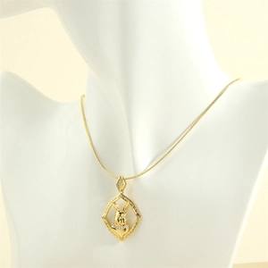Detail of 18K gold rabbit pendant with zircons and sleek snake chain on white bust