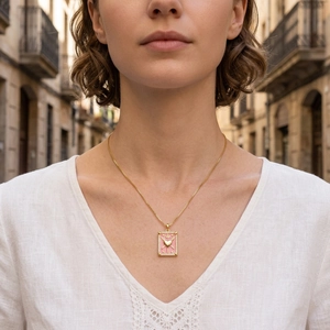 Detail of pink enamel tarot heart pendant necklace with gold chain and zircon stones