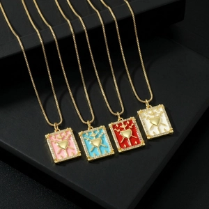 Detail of tarot card necklaces with 18k gold plating, enamel hearts, and zircon stones