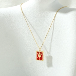 Detail of 18K gold-plated tarot heart pendant necklace with red enamel and zircon stones