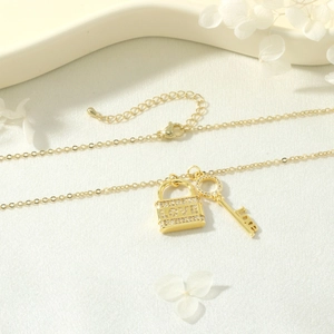Dettaglio della collana con lucchetto LOVE e chiave dorata con zirconi incastonati