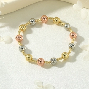 Three-tone beaded stretch bracelet with gold, silver and rose gold polished metal spheres