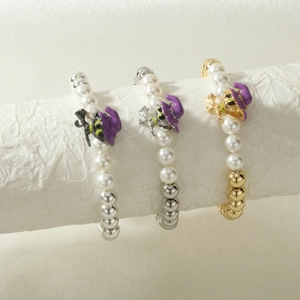 Detail of beaded bracelets with witch hat charms and pearls for Halloween gift