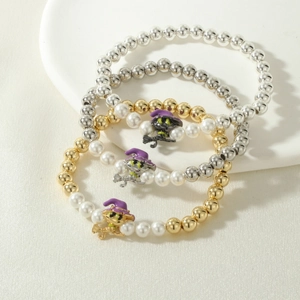 Close-up of witch charms on 3-piece Halloween stretch bracelets with pearls and metal beads