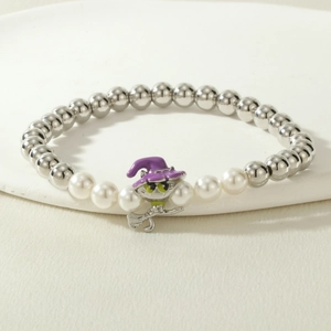 Detailed macro view of beaded Halloween bracelet with witch cat charm and pearls