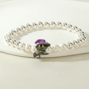 Detail of beaded Halloween bracelet featuring silver beads and black cat witch charm