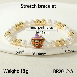 Macro shot of Halloween elastic bracelet with white faux pearls and pumpkin charm