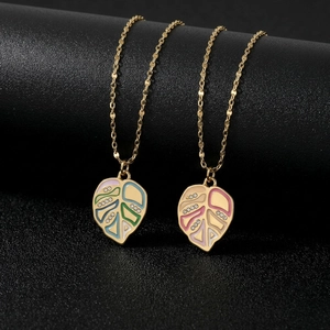 Minimalist gold leaf necklace with colorful enamel and sparkling crystal accents