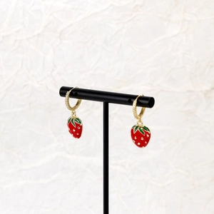 Exquisite red strawberry earrings with gold cubic zirconia hoops on black display
