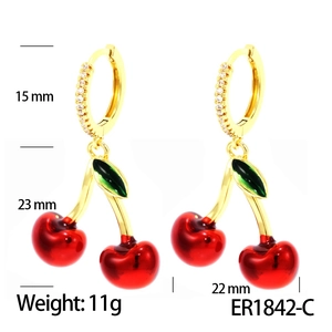 Detailed view of red cherry earrings with gold cubic zirconia hoops and size markers