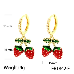 Detail view of red cherry earrings with 15mm gold hoops and green leaf accents