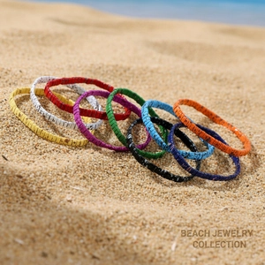 Bohemian colorful handmade beaded bracelets set of 9 on a sunny tropical beach background