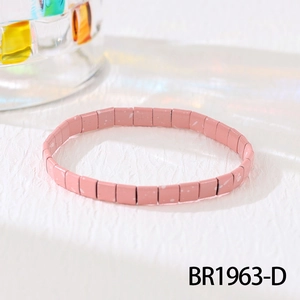 Macro shot of pink enamel Tila tile bracelet featuring white speckled art pattern