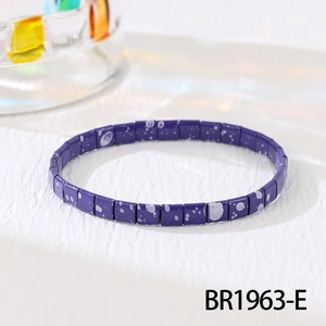 Detailed macro view of purple Tila bead stretch bracelet with white splatter pattern