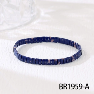 Detail of blue rectangular beads on handmade bohemian bracelet with brown spotted patterns