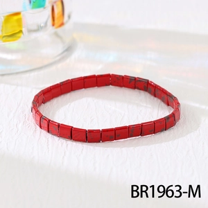 Detail of red and black spotted Tila tile beads on a flexible bohemian stretch bracelet