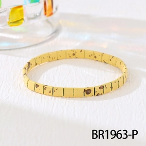 Detail shot of bright yellow Tila beads with brown spots on bohemian stretch bracelet