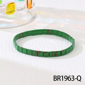 Detail of bohemian Tila bead stretch bracelet with green rectangular beads and brown spots