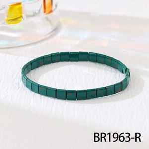 Detail of dark green Tila beaded bracelet with vintage reddish-brown patterns