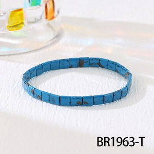 Detail view of sky blue Tila beads with brown splatter texture on a woven bracelet