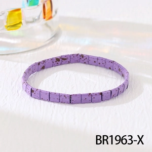 Close-up of Bohemian Tila bead bracelet featuring purple ink textures and elastic cord