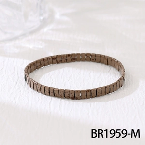 Macro detail of Bohemian brown glazed tile bracelet with dark speckled marble texture