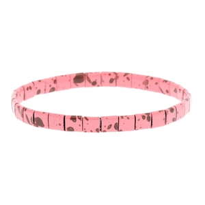 Bohemian colorful Tila beaded stretch bracelet with pink spotted square beads on white background
