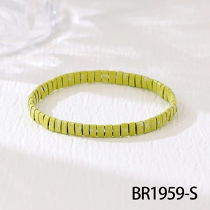 Detail of handmade green Tila bead bracelet with white speckled texture and glossy finish