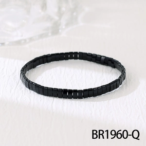 Vue macro de perles Tila noires à la finition brillante sur un bracelet bohème