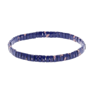 Detail of dark blue rectangular beads with pink splatter patterns on bohemian stretch bracelet