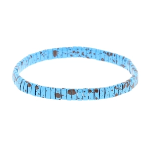 Bohemian sky blue Tila bead bracelet with brown ink splatter pattern on white background