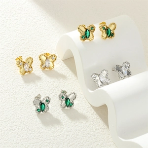 Detailed macro view of butterfly stud earrings with colorful zircon and carved wings