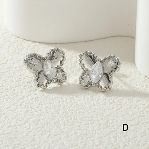 Macro shot of silver butterfly stud earring featuring marquise-cut sparkling zircon detail