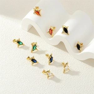 Macro detail of star stud earrings with colorful marquise zircons and gold plating