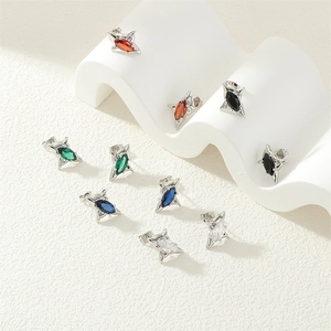Macro detail of star-shaped stud earrings with colorful marquise-cut zircon stones