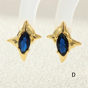 Detail of star-shaped earrings with gold plating and blue marquise cut zircon stones